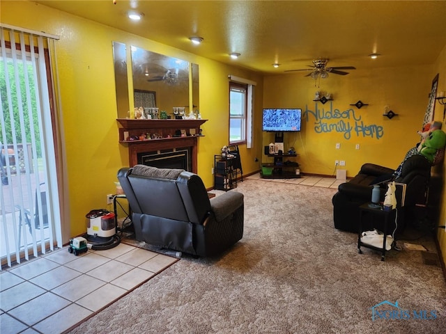 713 Glenwood Rd, Rossford, OH 43460 - carpeted living area with ceiling fan, a fireplace, and tile patterned floors