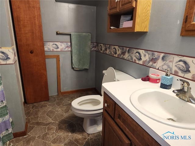 713 Glenwood Rd, Rossford, OH 43460 - bathroom with toilet, vanity, and stone finish flooring