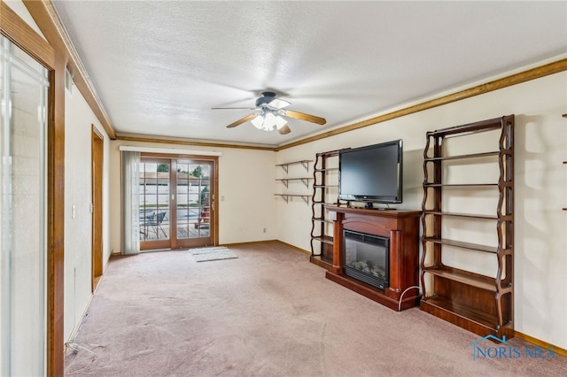 832 Maple Ln, Waterville, OH 43566 - unfurnished living room featuring carpet, a ceiling fan, baseboards, a glass covered fireplace, and crown molding