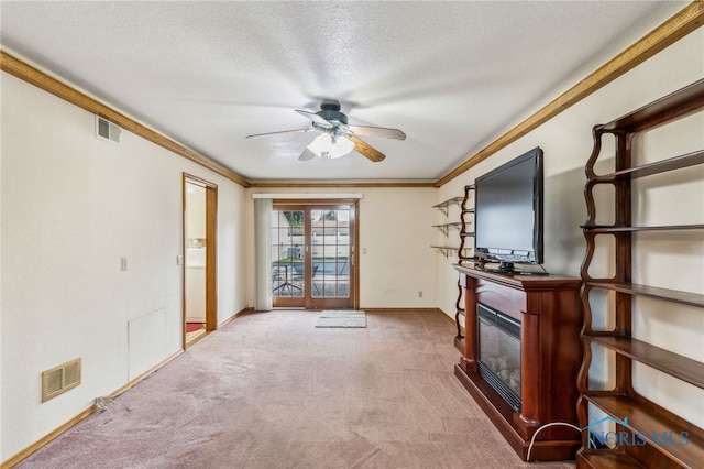832 Maple Ln, Waterville, OH 43566 - unfurnished living room with a ceiling fan, carpet flooring, crown molding, a glass covered fireplace, and baseboards