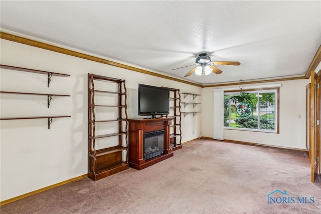 832 Maple Ln, Waterville, OH 43566 - unfurnished living room featuring ceiling fan, carpet flooring, a fireplace, baseboards, and ornamental molding