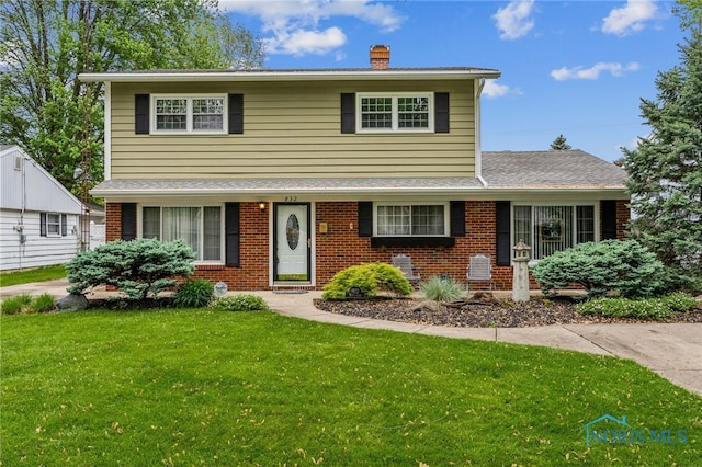 832 Maple Ln, Waterville, OH 43566 - view of front of property featuring brick siding, a front lawn, and a chimney