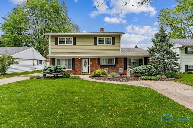 832 Maple Ln, Waterville, OH 43566 - traditional home featuring brick siding, a chimney, and a front lawn