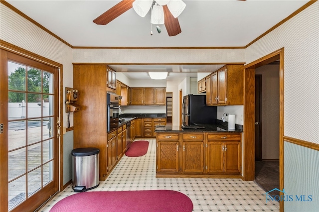 832 Maple Ln, Waterville, OH 43566 - kitchen featuring freestanding refrigerator, crown molding, brown cabinetry, wall oven, and ceiling fan
