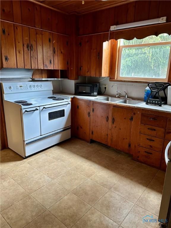 202 E Montford Ave, Ada, OH 45810 - kitchen featuring double oven range, black microwave, a sink, light countertops, and wood ceiling