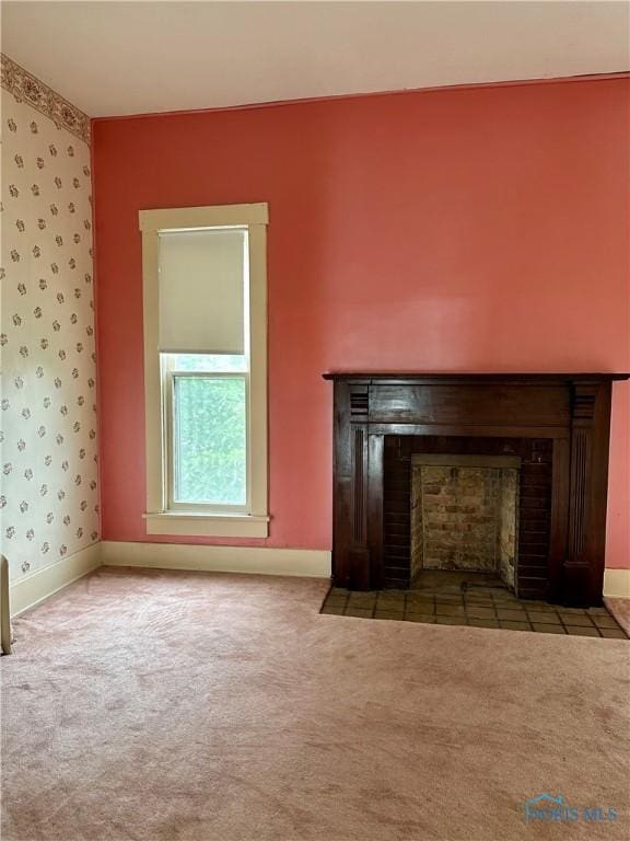 202 E Montford Ave, Ada, OH 45810 - unfurnished living room with a fireplace with flush hearth, carpet flooring, baseboards, and wallpapered walls