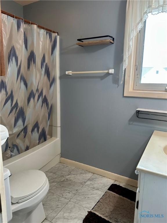 202 E Montford Ave, Ada, OH 45810 - bathroom featuring marble look tiles, toilet, baseboards, vanity, and shower / tub combo with curtain