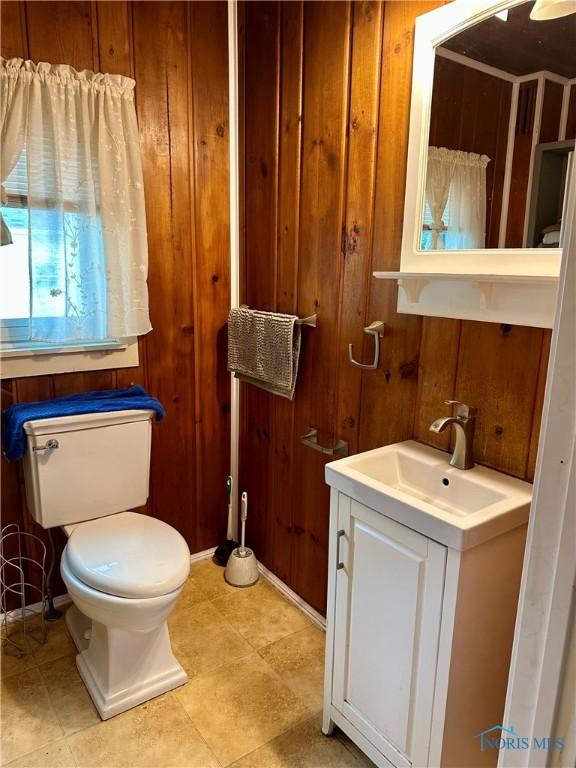 202 E Montford Ave, Ada, OH 45810 - half bath with wood walls, toilet, and vanity