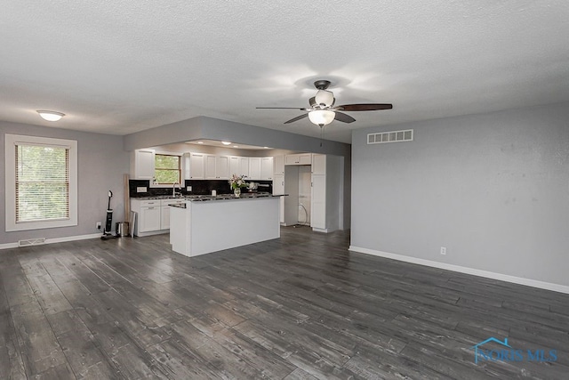 17315 County Road R, Napoleon, OH 43545 - kitchen with dark countertops, baseboards, white cabinetry, dark wood-style flooring, and a textured ceiling