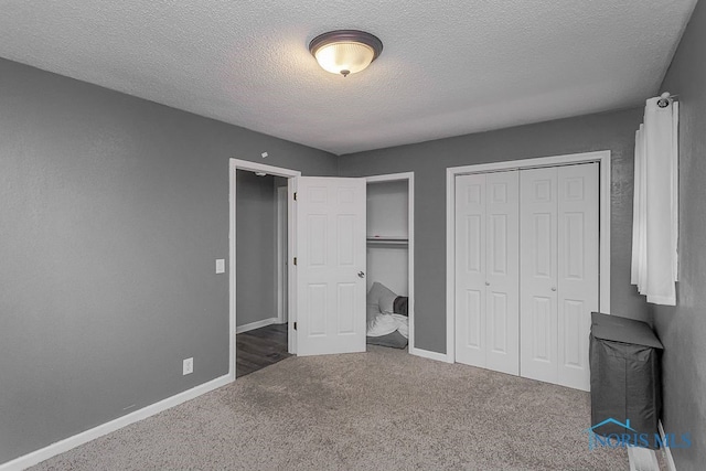 17315 County Road R, Napoleon, OH 43545 - unfurnished bedroom with carpet, a textured ceiling, multiple closets, and baseboards