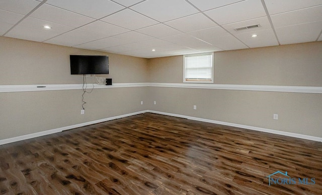 17315 County Road R, Napoleon, OH 43545 - below grade area with a drop ceiling, dark wood-style floors, and baseboards