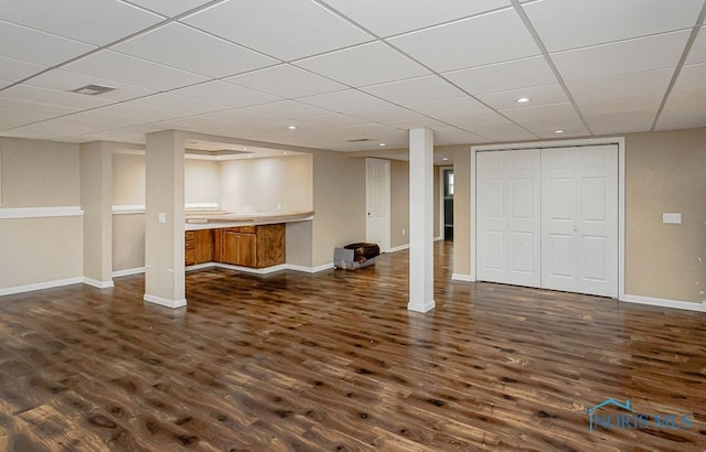 17315 County Road R, Napoleon, OH 43545 - finished basement with dark wood finished floors, a paneled ceiling, and baseboards