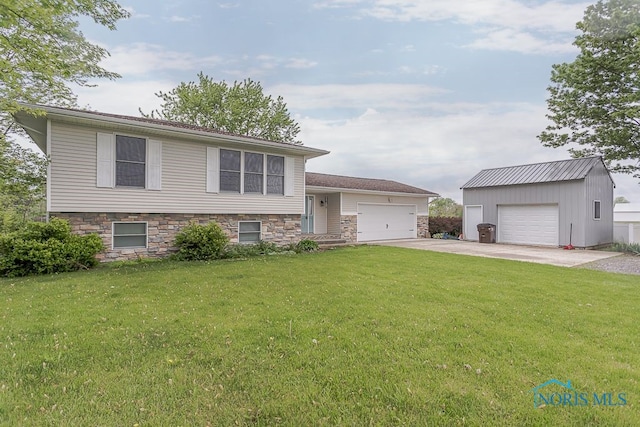 17315 County Road R, Napoleon, OH 43545 - tri-level home with a front lawn, stone siding, a garage, an outbuilding, and driveway