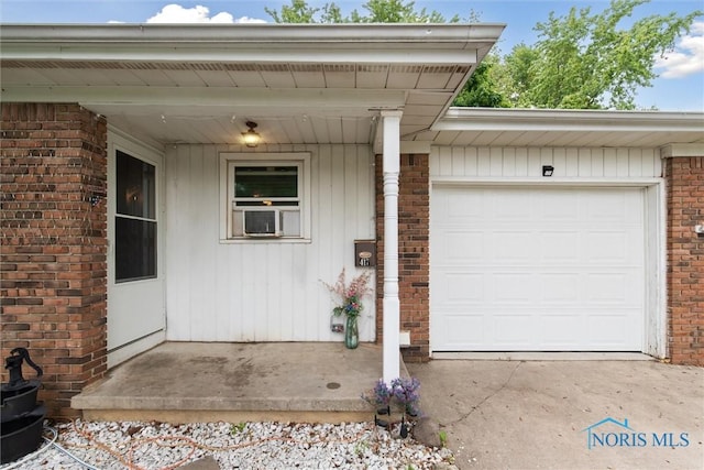 417 Indian Rd, Wauseon, OH 43567 - doorway to property featuring brick siding and an attached garage