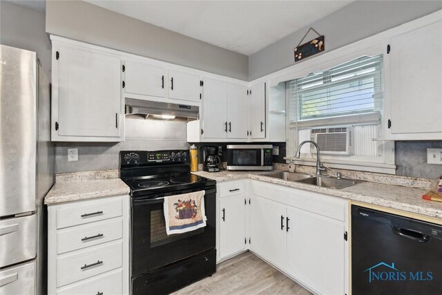 417 Indian Rd, Wauseon, OH 43567 - kitchen featuring black appliances, a sink, under cabinet range hood, and white cabinetry