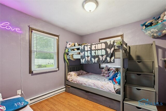 417 Indian Rd, Wauseon, OH 43567 - bedroom featuring a baseboard heating unit and wood finished floors