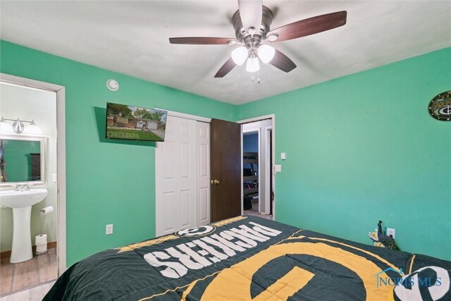 417 Indian Rd, Wauseon, OH 43567 - bedroom featuring a closet, ceiling fan, ensuite bathroom, wood finished floors, and a sink