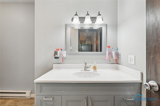 417 Indian Rd, Wauseon, OH 43567 - bathroom featuring a baseboard heating unit and vanity