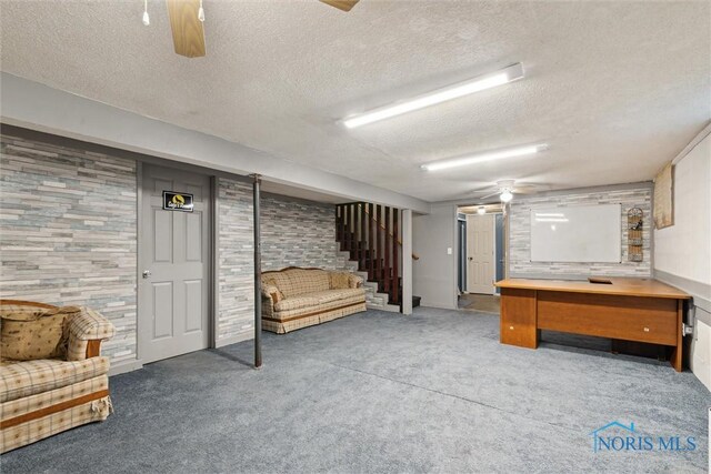 417 Indian Rd, Wauseon, OH 43567 - finished basement with a textured ceiling, ceiling fan, carpet, and stairway