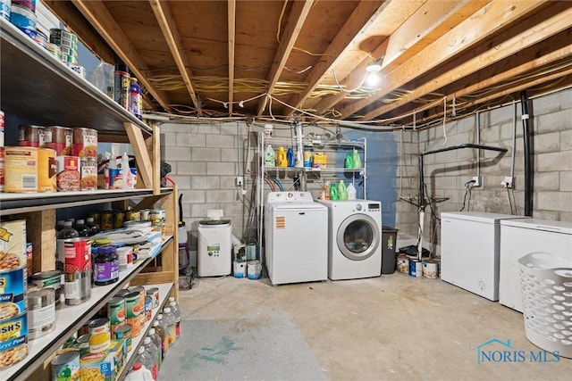 417 Indian Rd, Wauseon, OH 43567 - unfinished basement featuring independent washer and dryer, fridge, and concrete block wall
