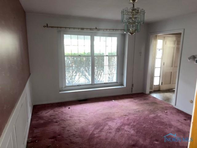 3777 Treelawn Dr, Toledo, OH 43614 - unfurnished dining area featuring carpet floors and a chandelier