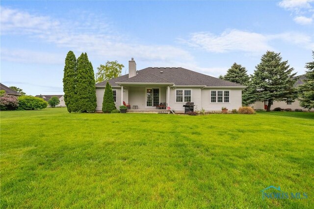 5723 Timbers Grn, Waterville, OH 43566 - back of property with a chimney and a lawn