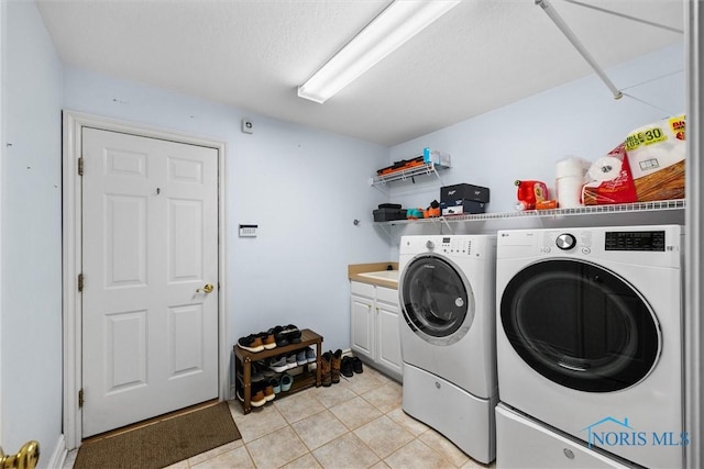 5723 Timbers Grn, Waterville, OH 43566 - washroom featuring washer and dryer, light tile patterned floors, and cabinet space