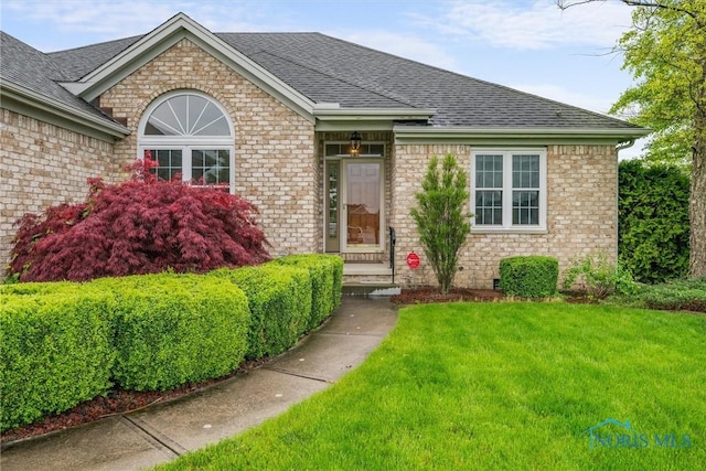 5723 Timbers Grn, Waterville, OH 43566 - view of front facade with a shingled roof, a front yard, and brick siding