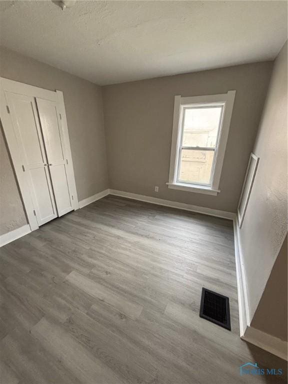 3907 Lagrange St, Toledo, OH 43612 - unfurnished bedroom with dark wood-style flooring and baseboards