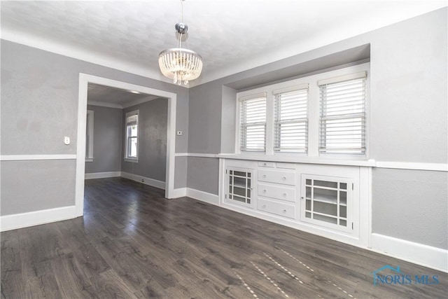 4202 Asbury Dr, Toledo, OH 43612 - spare room featuring a chandelier, healthy amount of natural light, baseboards, and dark wood-style floors