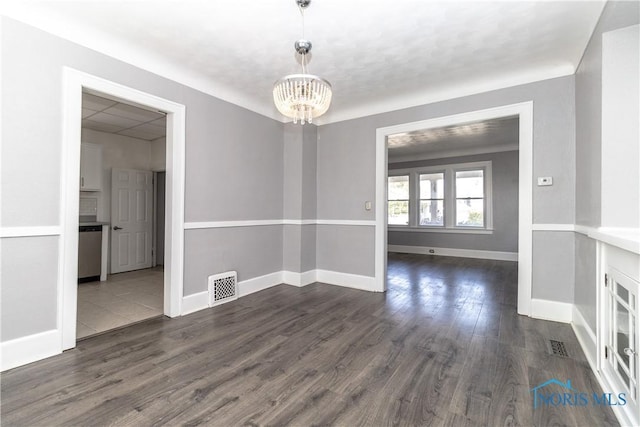4202 Asbury Dr, Toledo, OH 43612 - unfurnished dining area with a chandelier, dark wood finished floors, and baseboards