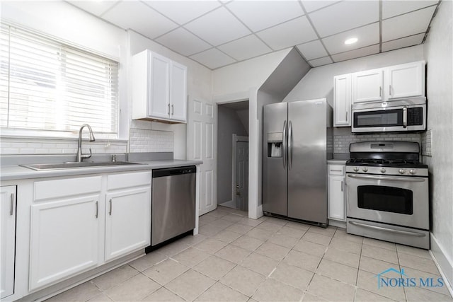 4202 Asbury Dr, Toledo, OH 43612 - kitchen with appliances with stainless steel finishes, a sink, backsplash, white cabinetry, and light countertops