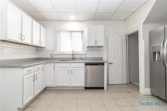 4202 Asbury Dr, Toledo, OH 43612 - kitchen with stainless steel appliances, a sink, a drop ceiling, white cabinetry, and decorative backsplash