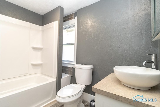 4202 Asbury Dr, Toledo, OH 43612 - full bath featuring toilet, a textured wall, vanity, shower / tub combination, and baseboards