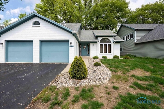 2008 Rush Creek Ct, Findlay, OH 45840 - ranch-style house with an attached garage, asphalt driveway, and brick siding