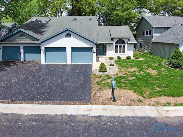 2008 Rush Creek Ct, Findlay, OH 45840 - view of front of home featuring an attached garage, asphalt driveway, and a front yard