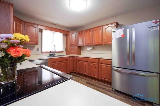 2008 Rush Creek Ct, Findlay, OH 45840 - kitchen featuring appliances with stainless steel finishes, a sink, dark wood-type flooring, light countertops, and brown cabinets