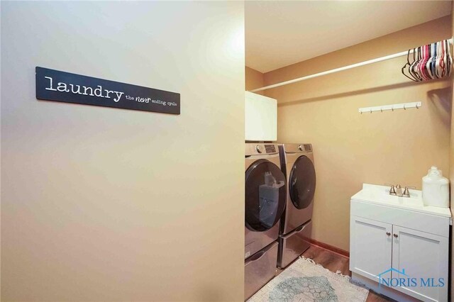 2008 Rush Creek Ct, Findlay, OH 45840 - clothes washing area with separate washer and dryer, cabinet space, and dark wood finished floors