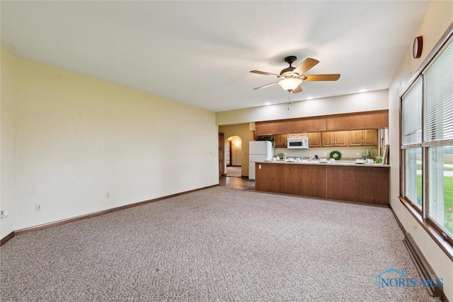 2454 Adams Ridge Rd, Defiance, OH 43512 - kitchen featuring white appliances, carpet floors, open floor plan, and brown cabinetry