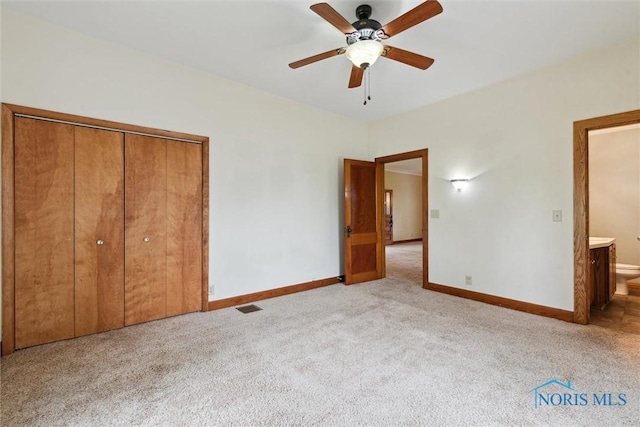 2454 Adams Ridge Rd, Defiance, OH 43512 - unfurnished bedroom featuring carpet flooring, baseboards, a closet, a ceiling fan, and ensuite bathroom