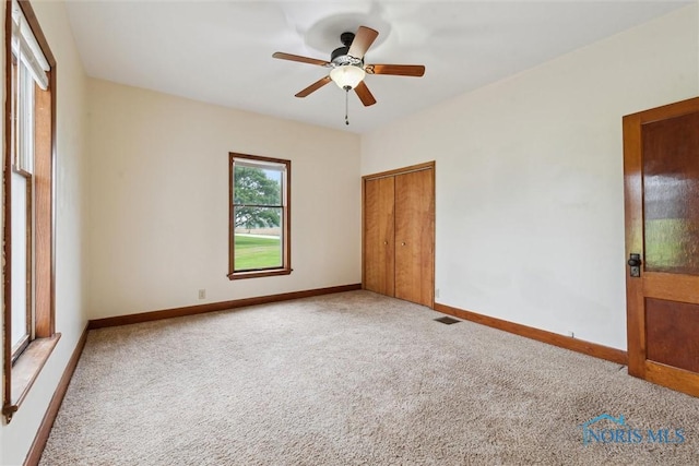 2454 Adams Ridge Rd, Defiance, OH 43512 - unfurnished bedroom featuring carpet flooring, baseboards, a closet, and a ceiling fan