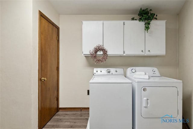 2454 Adams Ridge Rd, Defiance, OH 43512 - laundry area with cabinet space, washer and clothes dryer, light wood-type flooring, and baseboards