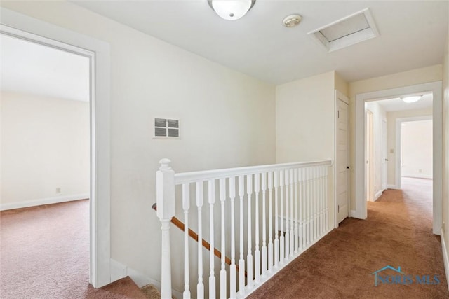 2454 Adams Ridge Rd, Defiance, OH 43512 - corridor featuring an upstairs landing, carpet, attic access, and baseboards