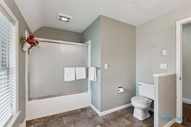 2454 Adams Ridge Rd, Defiance, OH 43512 - bathroom with bath / shower combo with glass door, baseboards, toilet, stone finish floors, and plenty of natural light