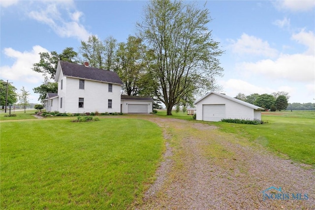 2454 Adams Ridge Rd, Defiance, OH 43512 - view of property exterior featuring a detached garage, a yard, an outdoor structure, and driveway