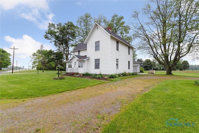2454 Adams Ridge Rd, Defiance, OH 43512 - view of property exterior featuring a lawn, driveway, a chimney, a garage, and a shingled roof