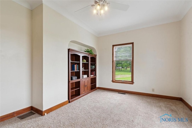 2454 Adams Ridge Rd, Defiance, OH 43512 - unfurnished room featuring carpet, baseboards, a ceiling fan, and arched walkways