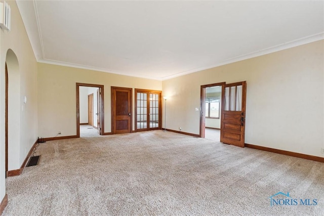 2454 Adams Ridge Rd, Defiance, OH 43512 - unfurnished room with arched walkways, ornamental molding, carpet, and baseboards