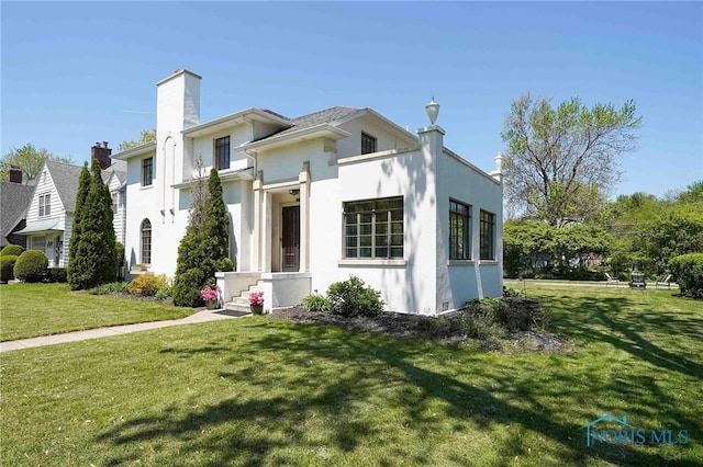 218 E Mcpherson Ave, Findlay, OH 45840 - back of property featuring a yard, stucco siding, and a chimney