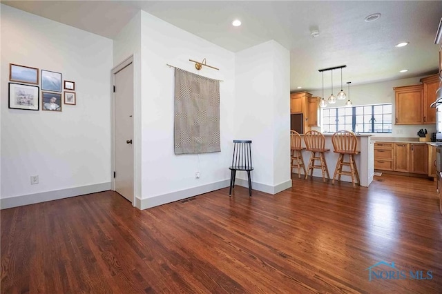 218 E Mcpherson Ave, Findlay, OH 45840 - living room featuring dark wood-style floors, recessed lighting, baseboards, and a chandelier